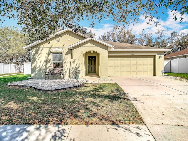 view of front of home with a garage, concrete driveway, fence, a front lawn, and stucco siding