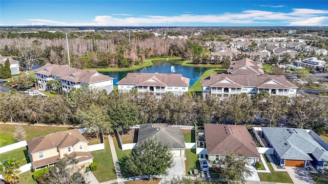 birds eye view of property with a water view and a residential view