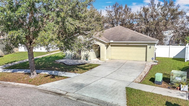 ranch-style home featuring stucco siding, a front yard, fence, a garage, and driveway