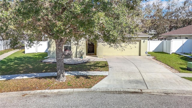 obstructed view of property with a garage, concrete driveway, fence, and stucco siding