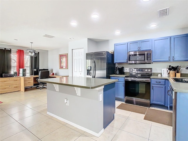 kitchen with blue cabinets, light tile patterned floors, stainless steel appliances, and a center island