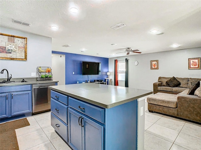 kitchen with stainless steel dishwasher, open floor plan, a kitchen island, a sink, and blue cabinets