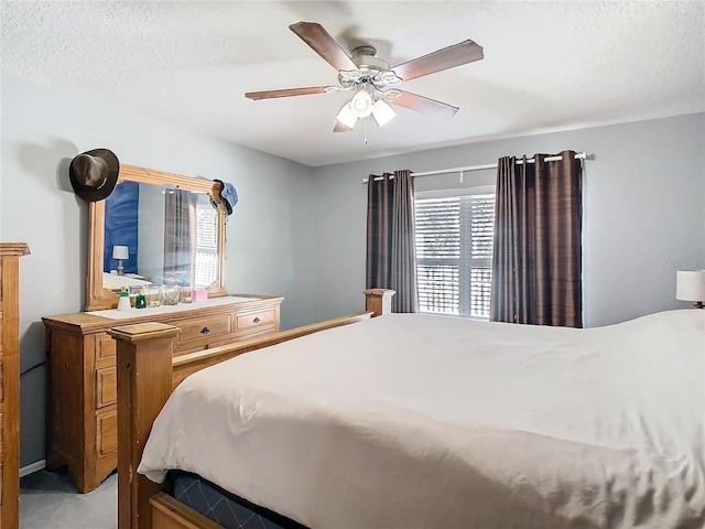 bedroom featuring ceiling fan and a textured ceiling