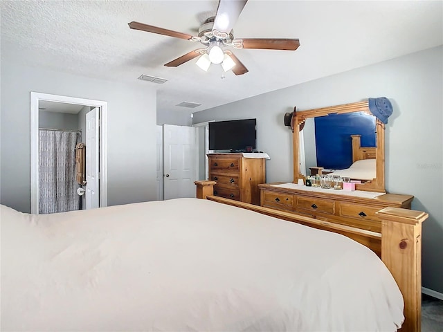 bedroom with visible vents, a textured ceiling, and a ceiling fan