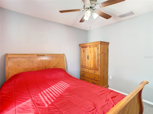 bedroom featuring ceiling fan, visible vents, and baseboards