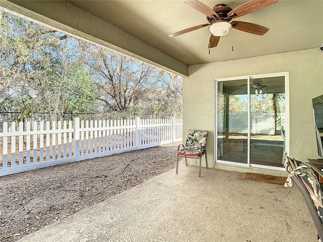 view of patio / terrace featuring ceiling fan and fence