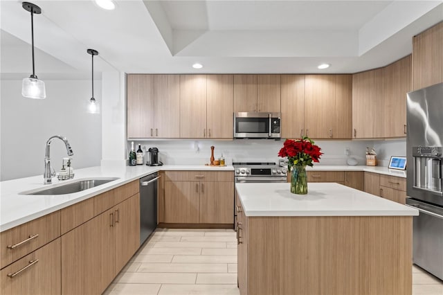 kitchen featuring recessed lighting, a kitchen island, a sink, light countertops, and appliances with stainless steel finishes