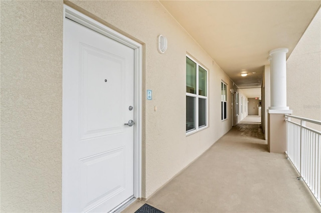 entrance to property featuring stucco siding