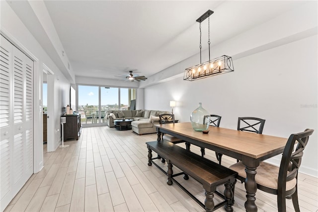 dining area featuring light wood-type flooring and a ceiling fan