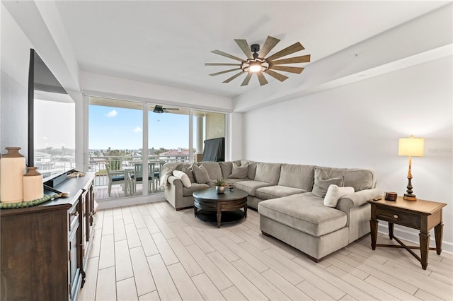 living area with light wood-type flooring and ceiling fan