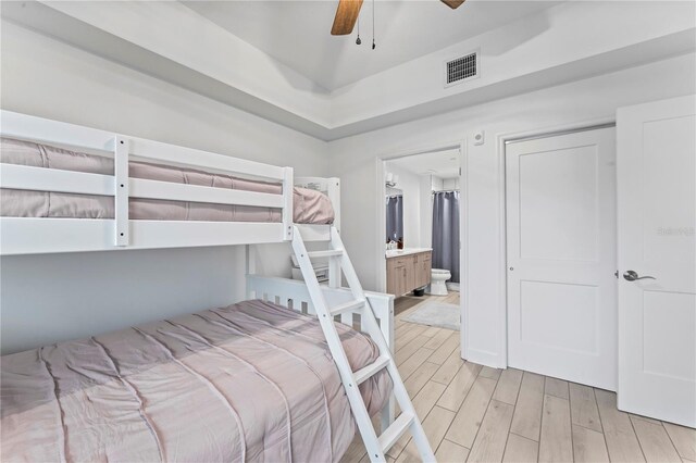 bedroom with a ceiling fan, light wood-type flooring, and visible vents