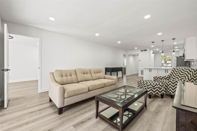 2101 Cordova Grn, Seminole, FL 33777 - living room with light wood finished floors, baseboards, visible vents, and recessed lighting