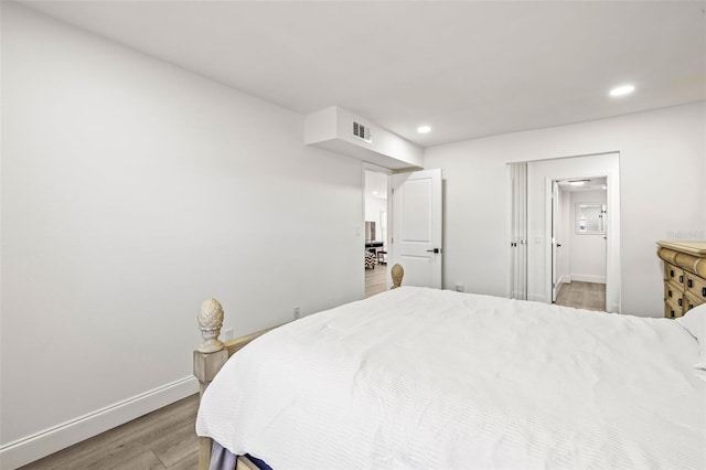 2101 Cordova Grn, Seminole, FL 33777 - bedroom with light wood-style floors, recessed lighting, visible vents, and baseboards