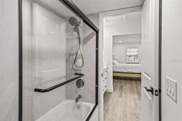 2101 Cordova Grn, Seminole, FL 33777 - ensuite bathroom with shower / bath combination with glass door, vanity, ensuite bath, and wood finished floors
