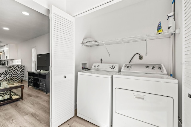 2101 Cordova Grn, Seminole, FL 33777 - clothes washing area with light wood-type flooring, laundry area, washer and clothes dryer, and recessed lighting