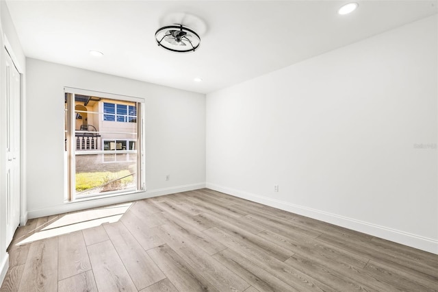2101 Cordova Grn, Seminole, FL 33777 - spare room featuring light wood-style floors, recessed lighting, a healthy amount of sunlight, and baseboards