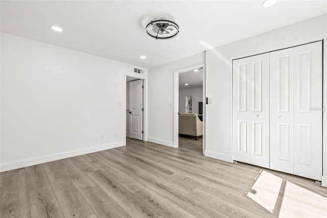 2101 Cordova Grn, Seminole, FL 33777 - unfurnished bedroom featuring light wood finished floors, recessed lighting, visible vents, and baseboards