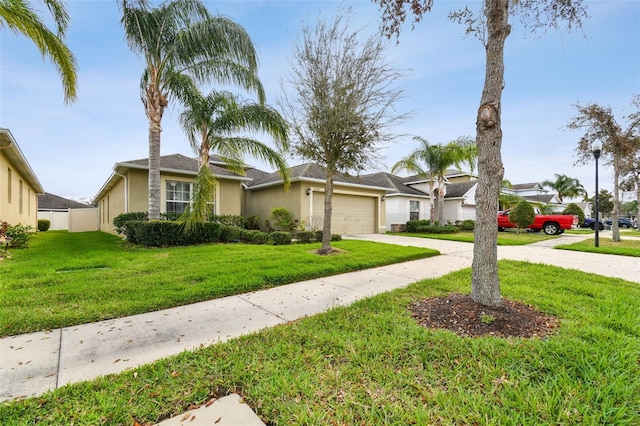 view of front of house featuring concrete driveway, a front lawn, an attached garage, and stucco siding