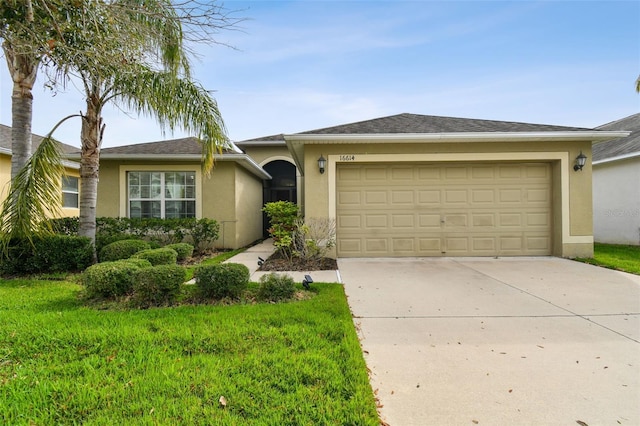 ranch-style house with driveway, a front yard, a garage, and stucco siding