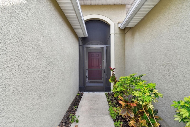 property entrance with stucco siding