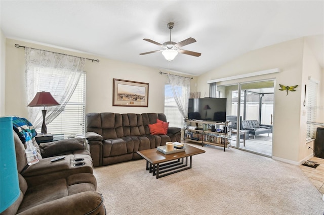 living room featuring lofted ceiling, baseboards, a ceiling fan, and light colored carpet