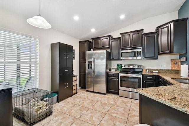 kitchen featuring light tile patterned floors, light stone counters, stainless steel appliances, vaulted ceiling, and pendant lighting