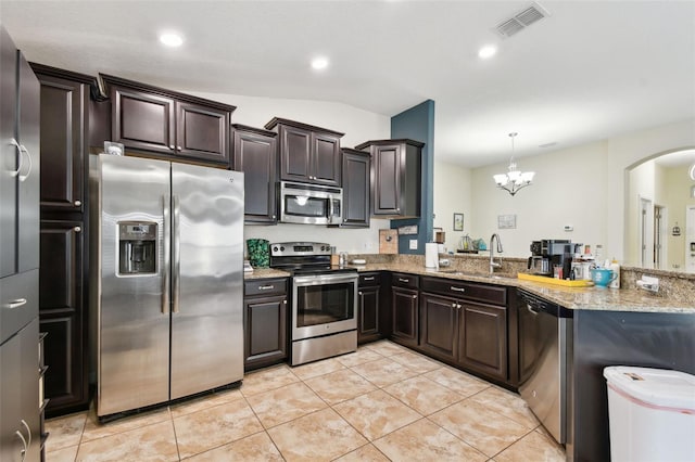 kitchen with stainless steel appliances, dark brown cabinets, a sink, and visible vents