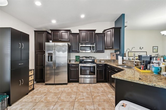 kitchen with dark brown cabinetry, light tile patterned floors, stainless steel appliances, a sink, and recessed lighting