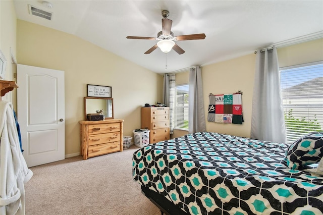 bedroom with lofted ceiling, ceiling fan, light carpet, and visible vents