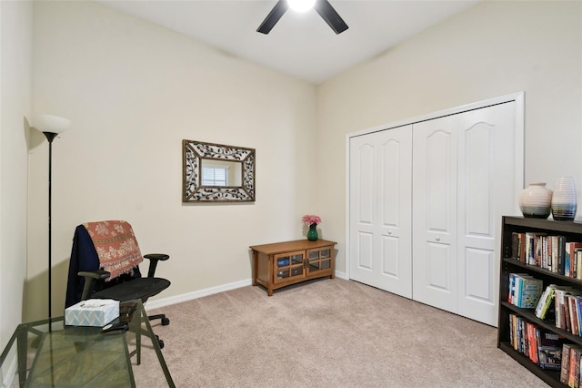 sitting room with a ceiling fan, light carpet, and baseboards