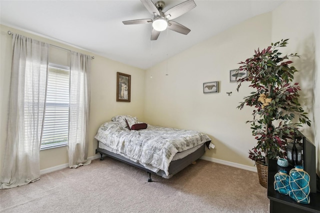 carpeted bedroom with ceiling fan, baseboards, and vaulted ceiling