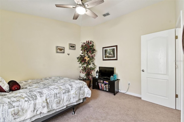 bedroom with a ceiling fan, light carpet, visible vents, and baseboards