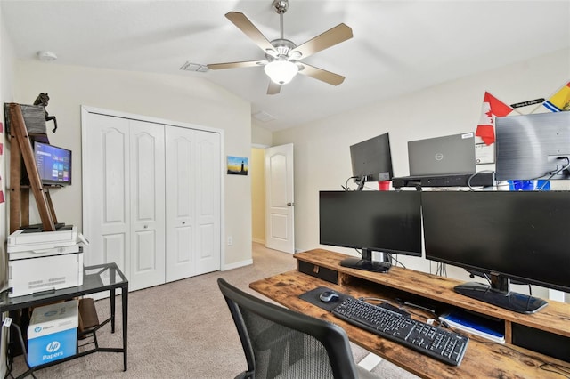 office featuring a ceiling fan, lofted ceiling, light carpet, and baseboards