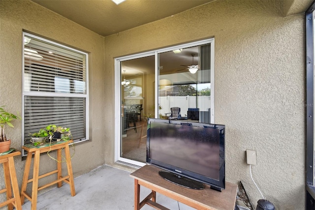 view of exterior entry with a patio area and stucco siding