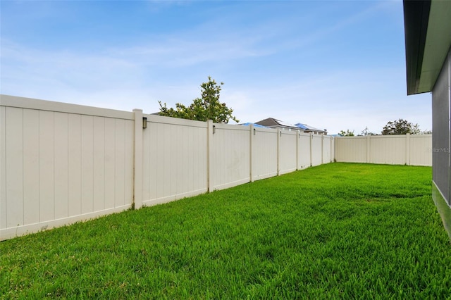 view of yard with a fenced backyard