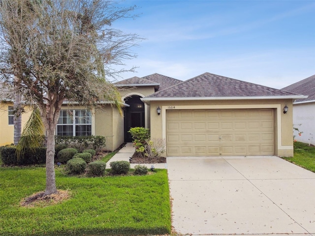 ranch-style home with a garage, a shingled roof, concrete driveway, a front lawn, and stucco siding