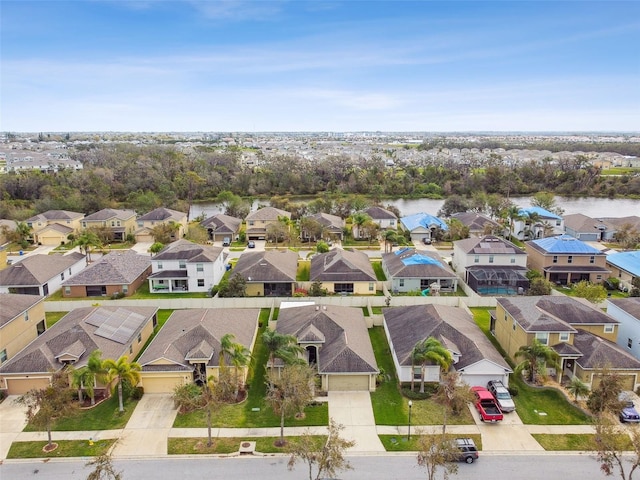 birds eye view of property with a residential view and a water view