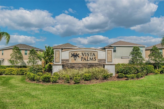 community / neighborhood sign featuring a lawn