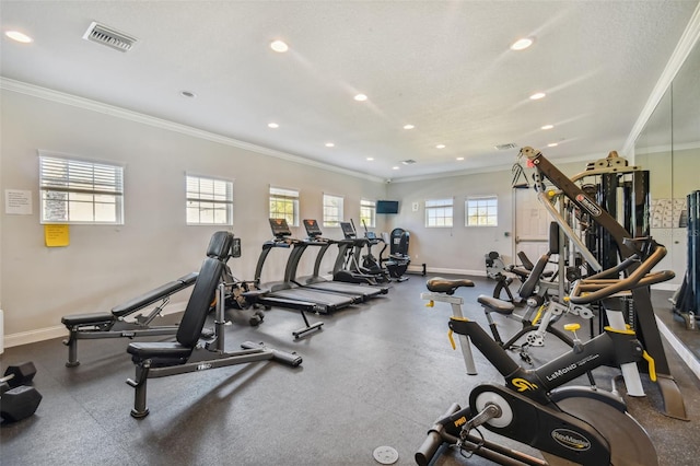 gym featuring baseboards, crown molding, and recessed lighting