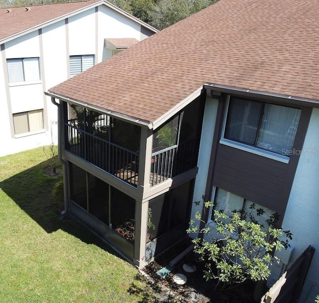 exterior details featuring gutters, a shingled roof, and a downspout