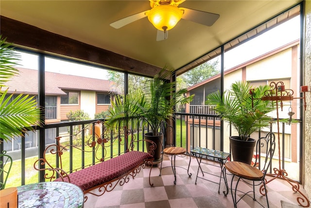 sunroom / solarium with a healthy amount of sunlight and ceiling fan