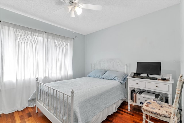 bedroom featuring a ceiling fan, a textured ceiling, and wood finished floors