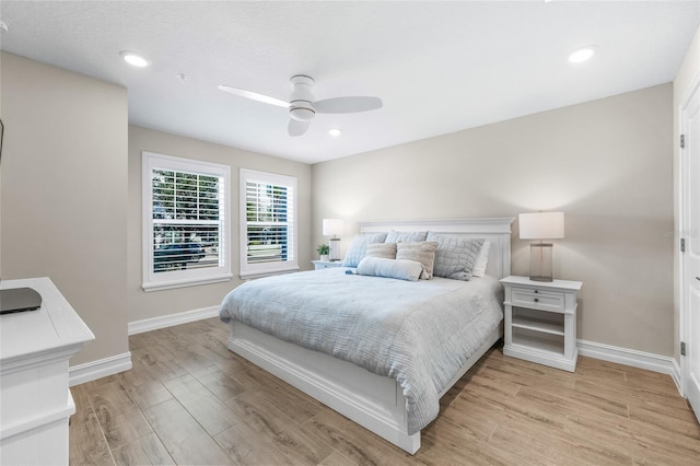 bedroom featuring a ceiling fan, recessed lighting, light wood-style flooring, and baseboards