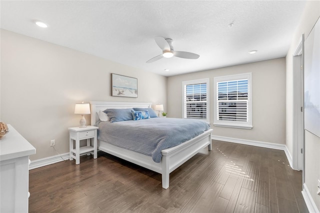 bedroom with ceiling fan, a textured ceiling, baseboards, and wood finished floors