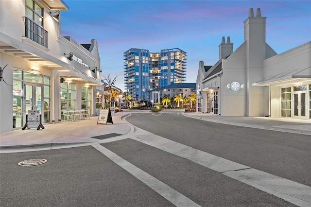 view of street featuring curbs, street lighting, and sidewalks