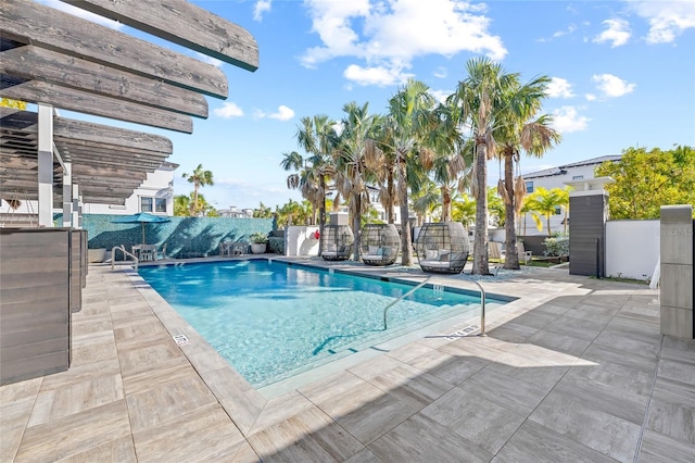 pool with fence and a patio