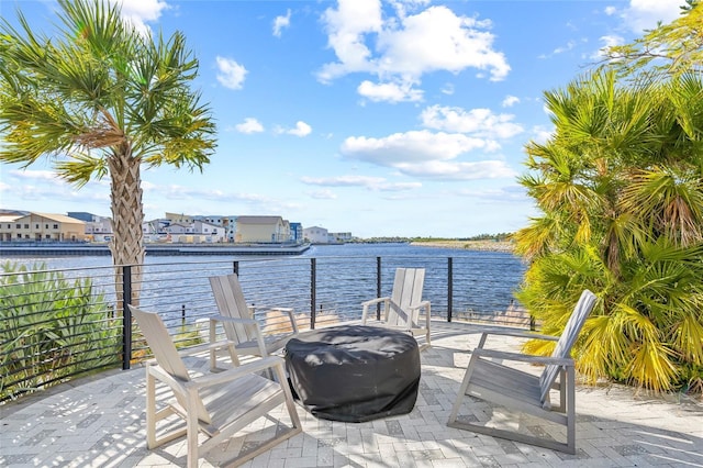 view of patio / terrace with a water view and a grill