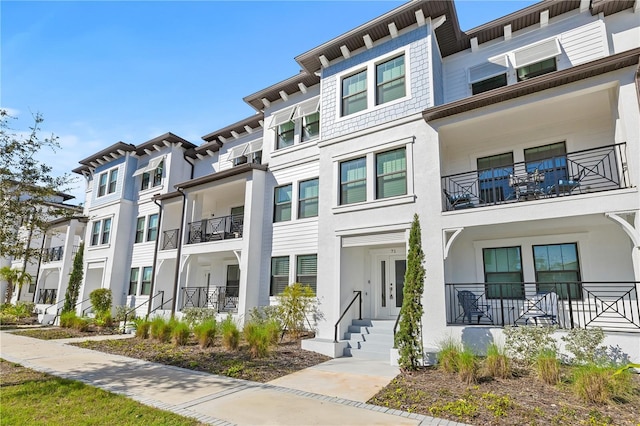 multi unit property featuring a residential view and stucco siding