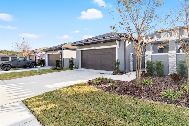 view of front facade with a garage, concrete driveway, a front yard, and stucco siding