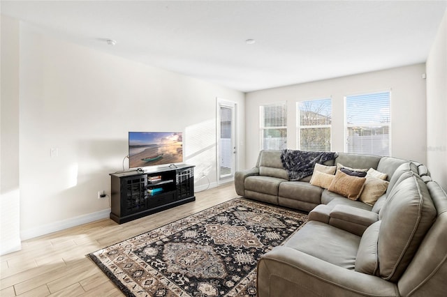 living room with baseboards and light wood-style floors